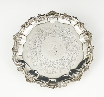 Lot 212 - A George II Rococo silver waiter, the rim...