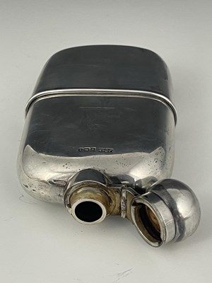 Lot 107 - An Edwardian silver hip flask, of rounded...