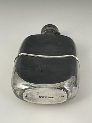 Lot 107 - An Edwardian silver hip flask, of rounded...
