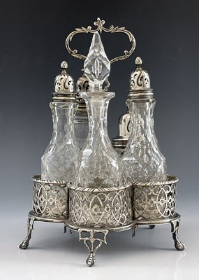 Lot 56 - A George III silver reticulated cruet stand and five cut glass bottles