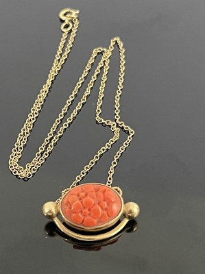 Lot 173 - A 9ct gold coral set pendant, with oval floral...