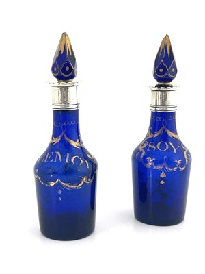 Lot 486 - A pair of silver mounted blue and gilt glass condiment bottles