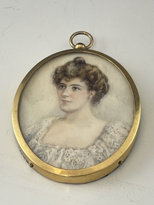 Lot 667 - An Edwardian portrait miniature, oval bust...