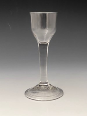 Lot 436 - A plain stemmed wine glass, circa 1740, the...