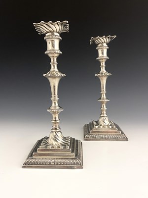 Lot 188 - A pair of George III cast silver candlesticks,...