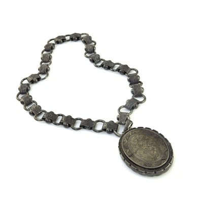 Lot 191 - A Victorian silver locket on chased chain...