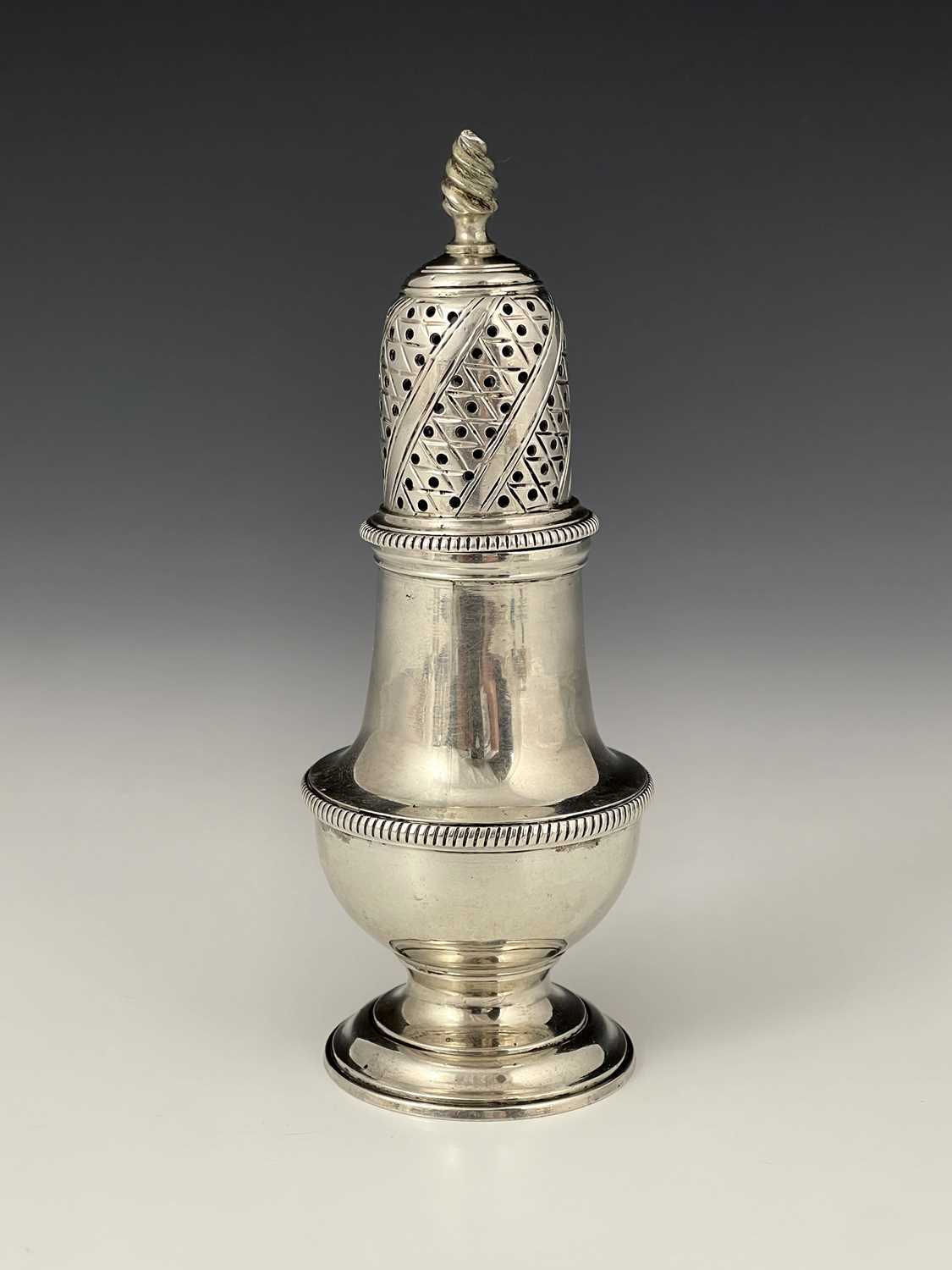 Lot 74 - A George III silver caster, of baluster form...