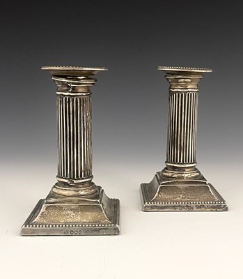 Lot 277 - A pair of George V silver candlesticks, of...