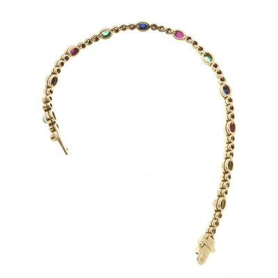 Lot 21 - An 18ct gold ruby, emerald, sapphire and diamond line bracelet