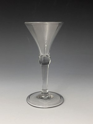 Lot 556 - A plain stemmed wine glass, circa 1740, the...