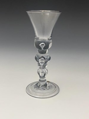 Lot 557 - An acorn knopped baluster wine glass, circa...