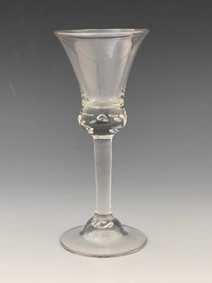 Lot 558 - An air drop wine glass, circa 1750, the large...