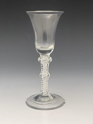 Lot 560 - A triple knopped opaque twist wine glass,...