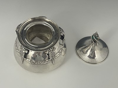 Lot 27 - An Edwardian Arts and Crafts silver inkwell,...