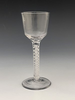 Lot 563 - An opaque twist wine glass, circa 1755, the...