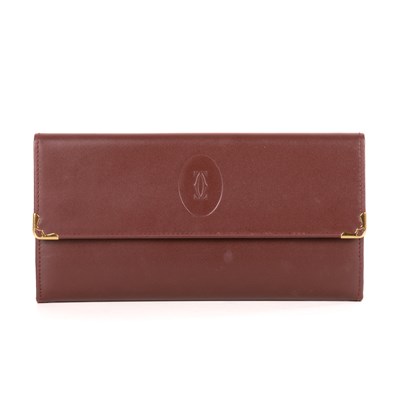 Lot 291 - Cartier, a Bordeaux purse, crafted from smooth...