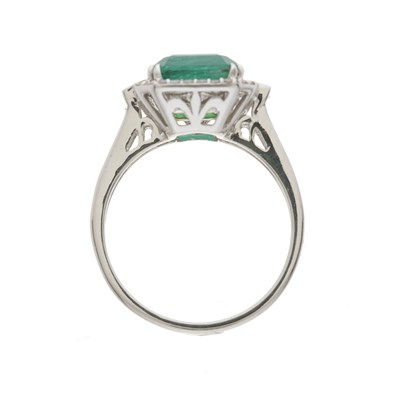 Lot 54 - An 18ct gold emerald and diamond cluster dress ring