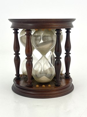 Lot 216 - A mahogany framed triple glass sand timer,...