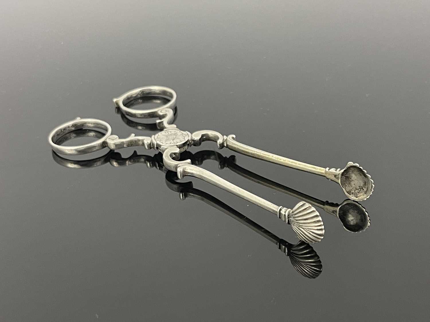 Lot 92 - A pair of Eighteenth-century silver tea tongs,...