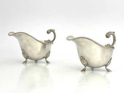 Lot 413 - A pair of George V silver sauce boats, each...