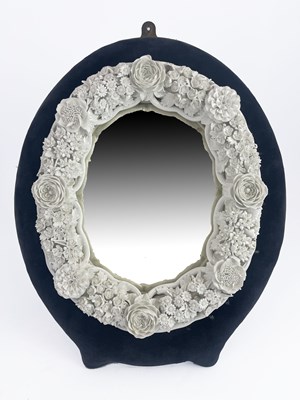 Lot 644 - A Continental porcelain framed oval mirror,...