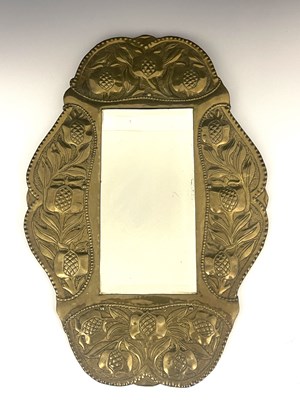 Lot 148 - An Arts and Crafts brass mirror, in the...
