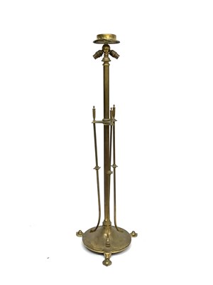 Lot 604 - An Arts and Crafts brass floor standing lamp...