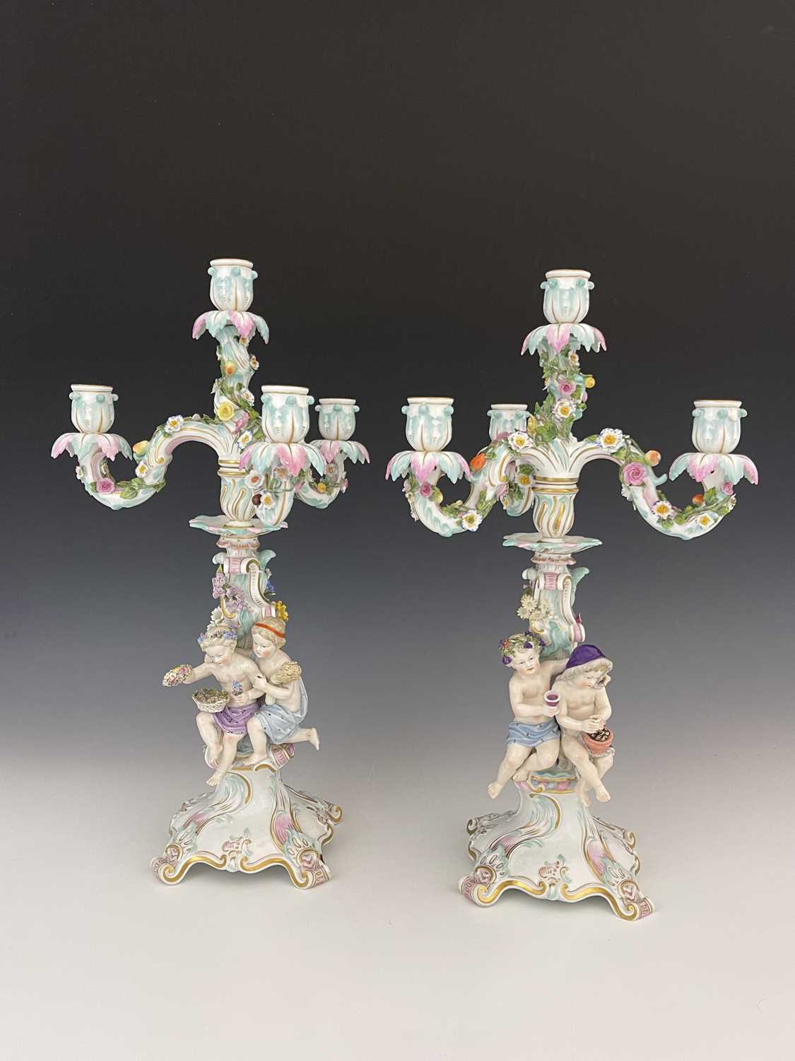 Lot 656 - A pair of Meissen three branch/four sconce...