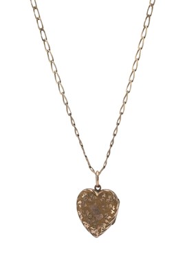 Lot 11 - An early 20th century engraved heart-shape locket pendant, with chain