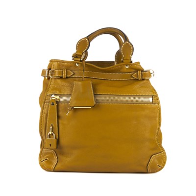 Lot 284 - Burberry, a mustard leather handbag, featuring...