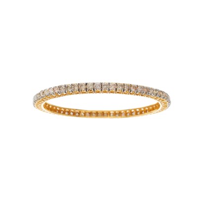 Lot 29 - A 14ct gold brilliant-cut diamond line bangle...