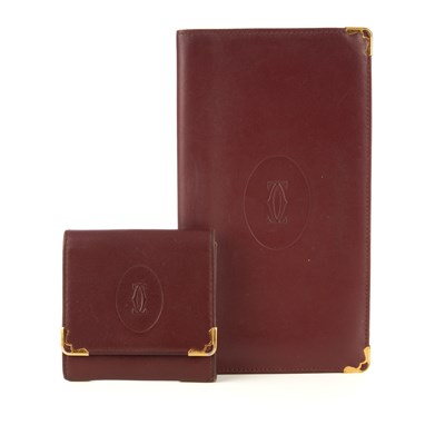 Lot 247 - Cartier, two Bordeaux leather wallets, to...