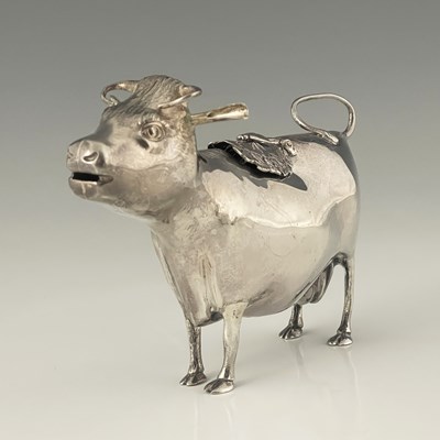 Lot 303 - An Elizabeth II novelty silver cow creamer,...