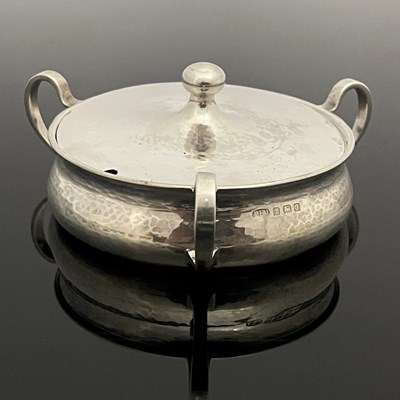 Lot 310 - A George V Arts and Crafts silver preserve...