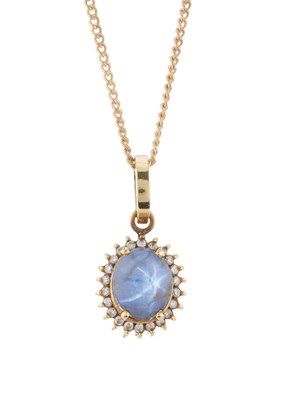 Lot 132 - A gold natural star sapphire and brilliant-cut...