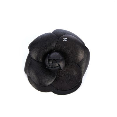 Lot 285 - Chanel, a Camellia brooch, featuring black...